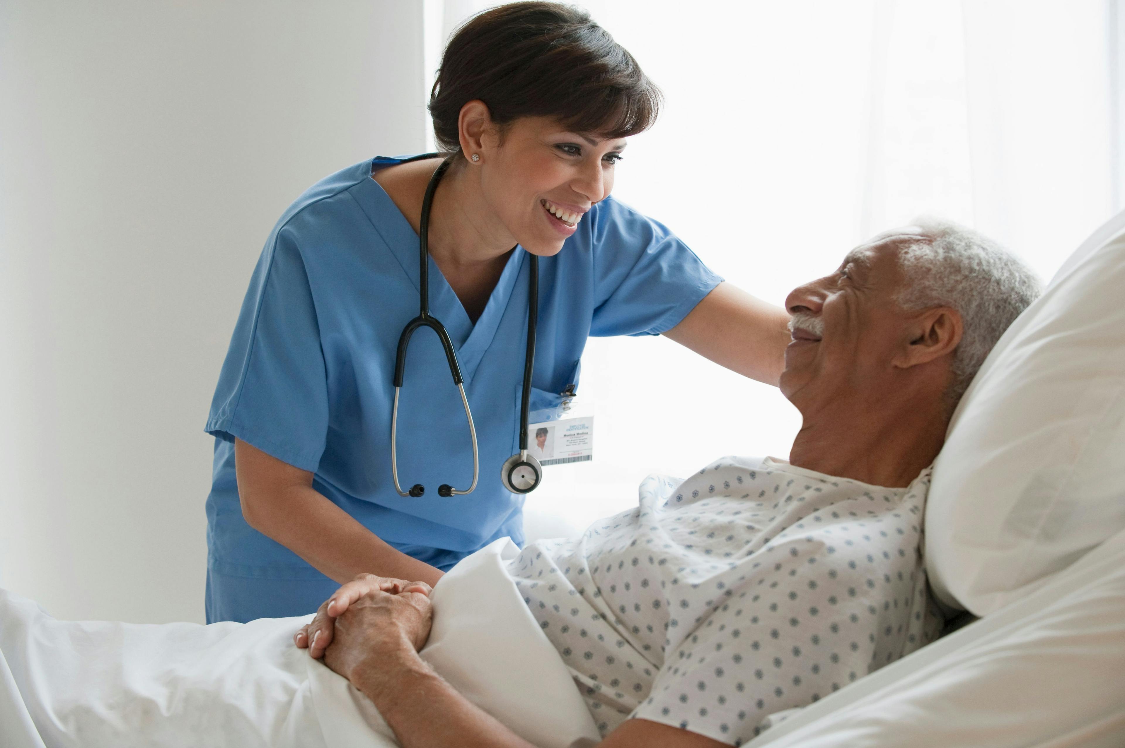 A female nurse takes care of an elderly male patient