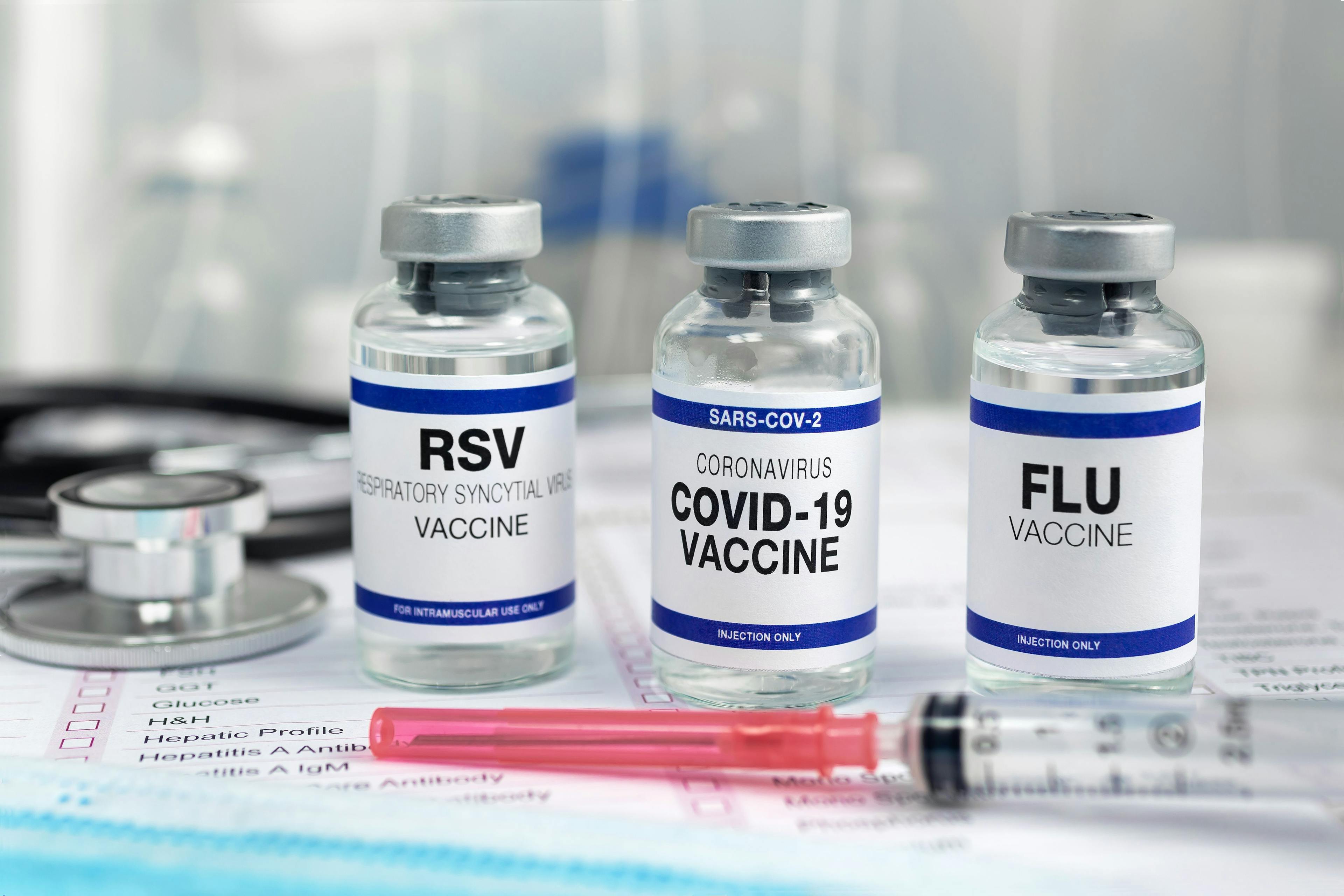 Three vials of vaccines for RSV, Covid and the flu